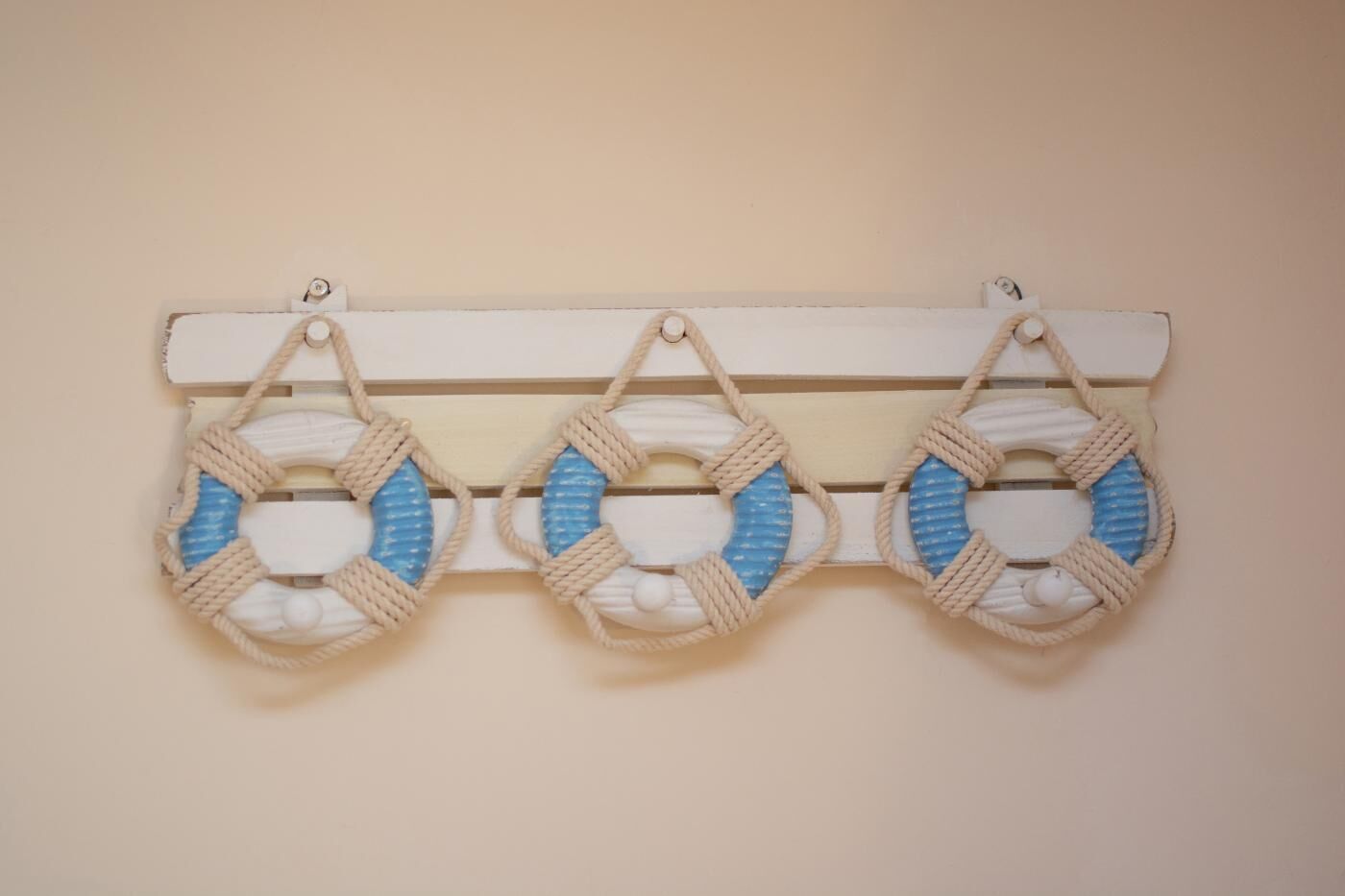 A wall-mounted decorative piece with three circular designs.