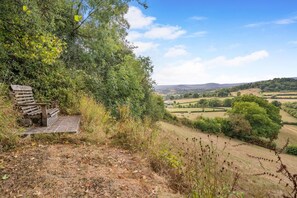 A bench in a natural setting overlooking a rural landscape with fields and distant hills. - 1 Bed in Trefeitha (oc-h32936) (Trefeitha)