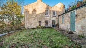 A stone building with a small garden and a green door. - 3 Bed in Bath (oc-bhr26) (Bath)