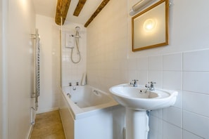 A bathroom with a bathtub, a sink, and a shower. - 3 Bed in Cromer (oc-387) (Cromer)