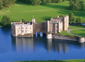 A castle with a moat, stone walls, and a grassy landscape. - 3 Bed in Benenden (oc-cb541) (Benenden)
