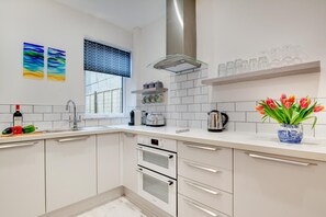 Oven, dishwasher, high chair, cookware/dishes/utensils