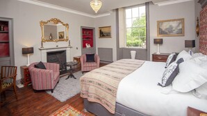A bedroom with a large bed, a fireplace, a chandelier, and a window with a view. - 2 Bed in Bath (oc-bhr35) (Bath)