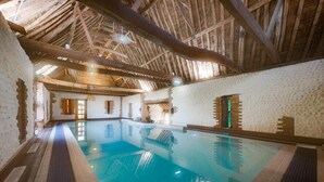 An indoor swimming pool with a high wooden ceiling and white textured walls. - 2 Bed in Bacton (oc-712) (Bacton)
