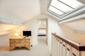 A bedroom with a skylight, a wooden dresser, a bed, and a staircase. - 5 Bed in Ulpha (oc-b32731) (Ulpha)