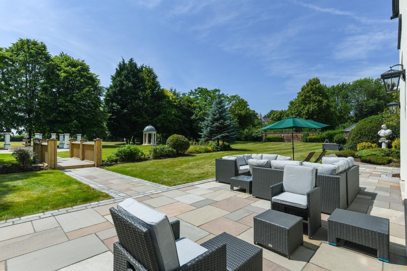 A patio area with outdoor furniture, a lawn, and a gazebo.