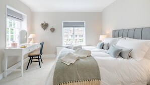A bedroom with a bed, bedside tables, a desk, a chair, and a window. - 2 Bed in East Brent (oc-k32780) (East Brent)