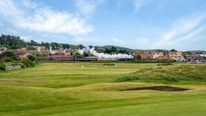 A golf course with a clear view of houses and a steam train in the background. - 3 Bed in Holt (oc-1331) (Bodham)