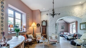 A cozy living room with a fireplace, comfortable seating, and a dining area with a table and chairs.