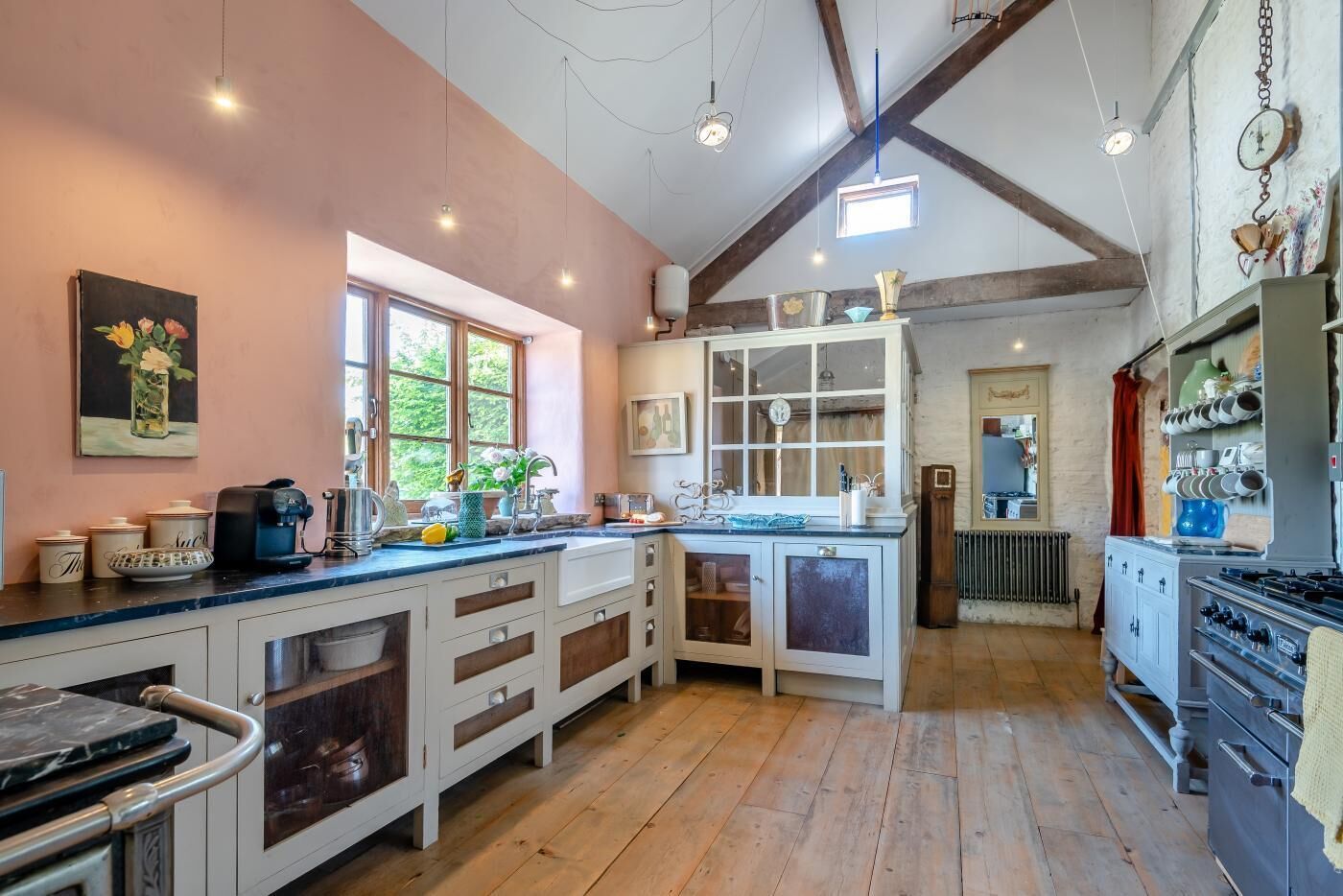 A kitchen with wooden cabinets, a large island, and a dining area with a table and chairs.