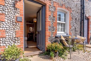 A stone facade building with a door leading to an interior space. - 1 Bed in Blakeney (oc-674) (Blakeney)