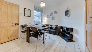A compact kitchen with a dining table, chairs, and a built-in bench. - 3 Bed in Broadstairs (oc-th006) (Broadstairs)