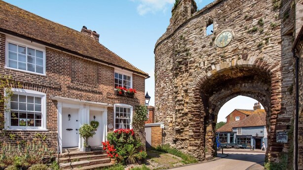 A stone archway, a brick building with a white door, and a small sign. - 2 Bed in Rye (oc-rh1045) (Rye)
