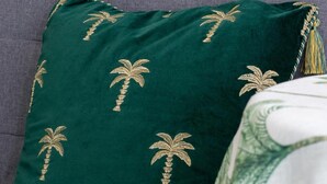 A green pillow with palm tree embroidery on a grey sofa. - 1 Bed in Saltdean (oc-bbidre) (Saltdean)