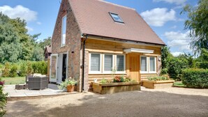 A two-story house with a sloped roof, a brick exterior, and a wooden front porch. - 1 Bed in Cranbrook (oc-cb652) (Cranbrook)