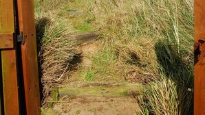 A wooden gate leading to a grassy path. - 3 Bed in Eccles Beach (oc-852) (Eccles-on-Sea)
