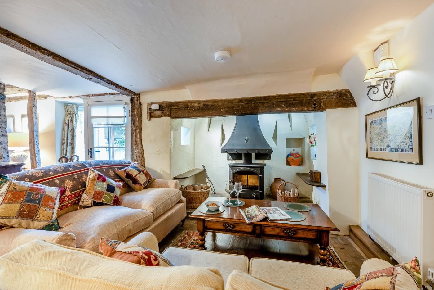 A cozy living room with a fireplace, a sofa set, and a dining table.
