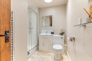 A modern bathroom with a glass shower enclosure, a white sink, and a toilet. - 3 Bed in Briston (oc-1167) (Briston)