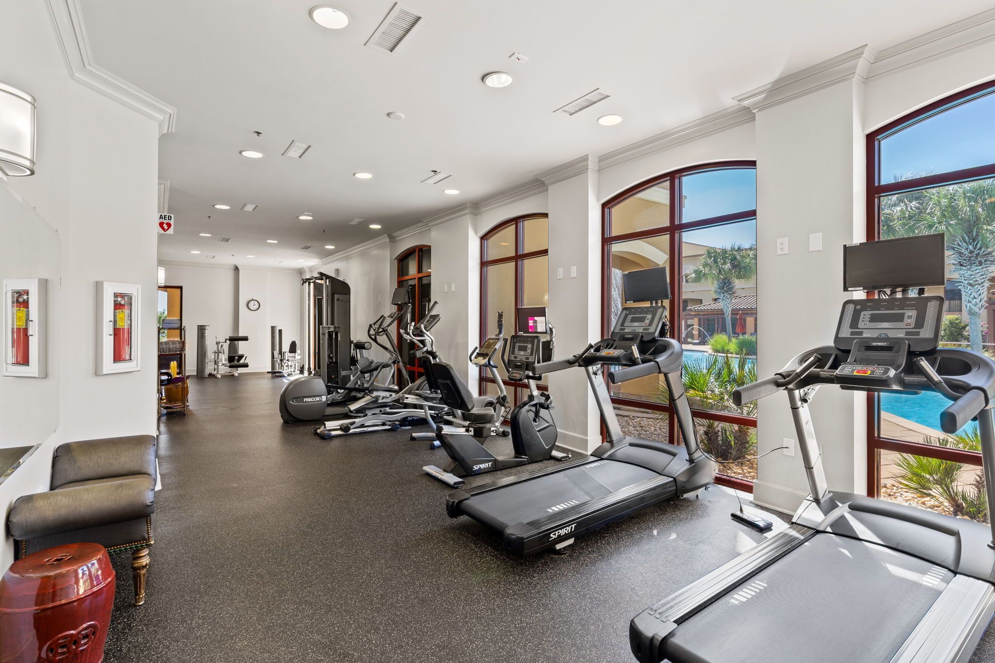 A gym with treadmills, stationary bikes, and weight machines.