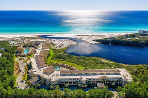 An aerial view of a resort with multiple buildings, a swimming pool, and a beach area. - Wonderful Condo on the Beach on 30A (Santa Rosa Beach)