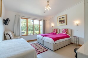 A bedroom with two beds, a chair, a desk, and a large window. - 2 Bed in Stelling Minnis (oc-ek716) (Lyminge)