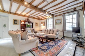 A cozy living room with a fireplace, comfortable seating, and a television.