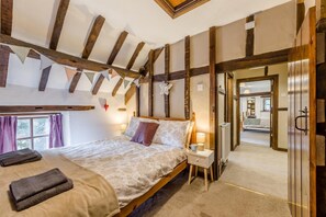 A bedroom with a bed, nightstand, and a view of another room. - 2 Bed in Llandefalle (oc-n32991) (Llandefalle)