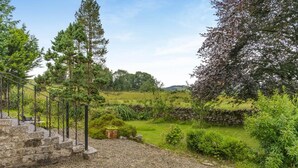 A garden with a stone wall, gravel path, and a metal staircase leading to a seating area. - 1 Bed in Crook (oc-gl077) (Crook)
