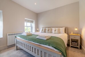 A bedroom with a bed, bedside table, lamp, and a window. - 2 Bed in West Witton (oc-l32707) (West Witton)