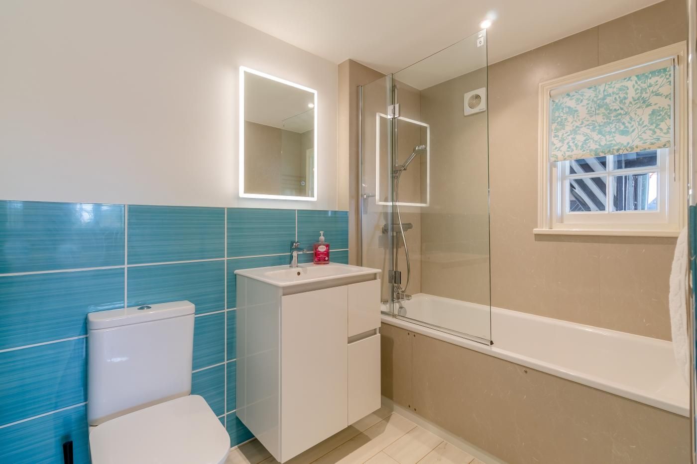 Ein Badezimmer mit Toilette, Waschbecken und Duschbereich.