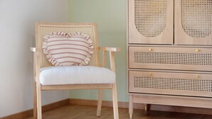 A wooden chair with a cushion, a ruffled pillow, and a wooden cabinet with drawers. - “Chambre Champêtre” Guest Room with Shared Terrace, Garden, and Wi-Fi (Mont-Dol)