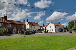 A traditional British pub with a sign 'The Cricketers' and a car parked in front. - 2 Bed in Aldborough (oc-2174) (Aldborough)