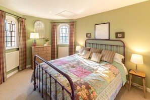 A bedroom with a bed, a dresser, a nightstand, and a window with curtains. - 2 Bed in Tunstall (oc-ivylod) (Rendlesham)