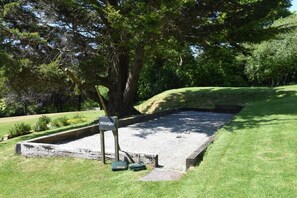 A billiards table labeled "PETANQUE" with cue sticks and balls, surrounded by a grassy area and trees. - 1 Bed in Two Waters Foot (oc-a27332) (Warleggan)
