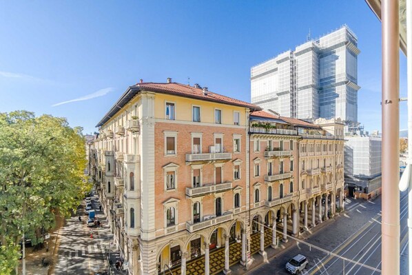 A historic building with multiple floors, large windows, and a central courtyard with columns.