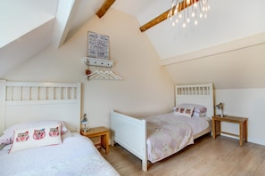 A bedroom with two beds, a wooden ceiling, a hanging light fixture, and a wall-mounted coat rack. - 2 Bed in Swanage (oc-wy467) (Swanage)