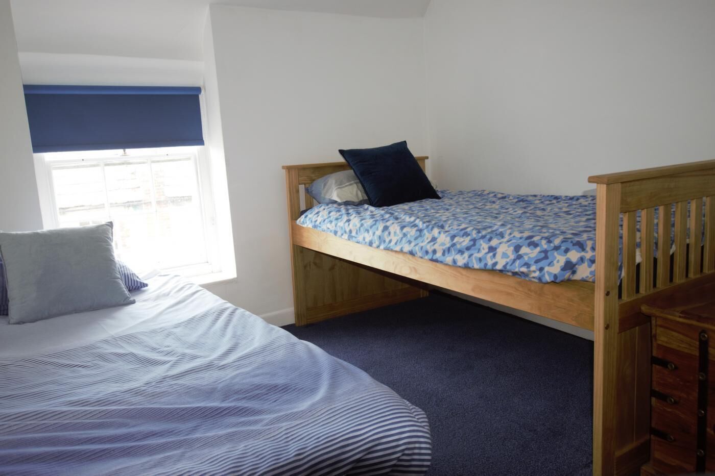A bedroom with a bunk bed and a single bed.