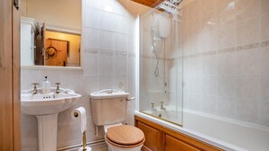 A bathroom with a wooden vanity, two sinks, a toilet, and a glass-enclosed shower. - 2 Bed in St. Hilary (oc-c33064) (Cowbridge)