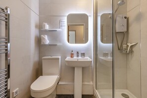 A modern bathroom with a toilet, sink, and shower. - 2 Bed in Swanage (oc-wy356) (Swanage)