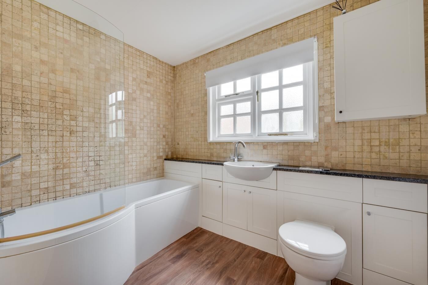 A bathroom with a bathtub, sink, and toilet.