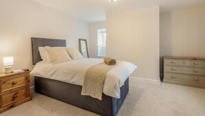A bedroom with a bed, bedside table, dresser, and a ceiling light. - 4 Bed in Bere Regis (oc-g33051) (Bere Regis)
