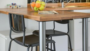 A kitchen counter with a bowl of fruit, a kettle, and a coffee machine. - 1 Bed in West Bay (oc-wy537) (West Bay)