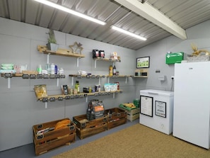 A kitchen with shelves stocked with various food items, a refrigerator, and wooden crates on the floor. - 1 Bed in Rocester (oc-w33053) (Barrow Hill)