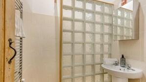 A bathroom with a glass shower enclosure, a white sink, and a towel rack. - 1 Bed in Oulton (oc-a32857) (Lowestoft)