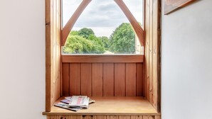 A wooden window with a view of trees and a clear sky. - 6 Bed in Three Holes (oc-t31855) (Upwell)