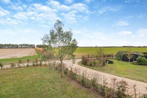 A rural landscape with a dirt path, a small building, and a field. - 1 Bed in Woodbridge (oc-meb) (Sudbourne)