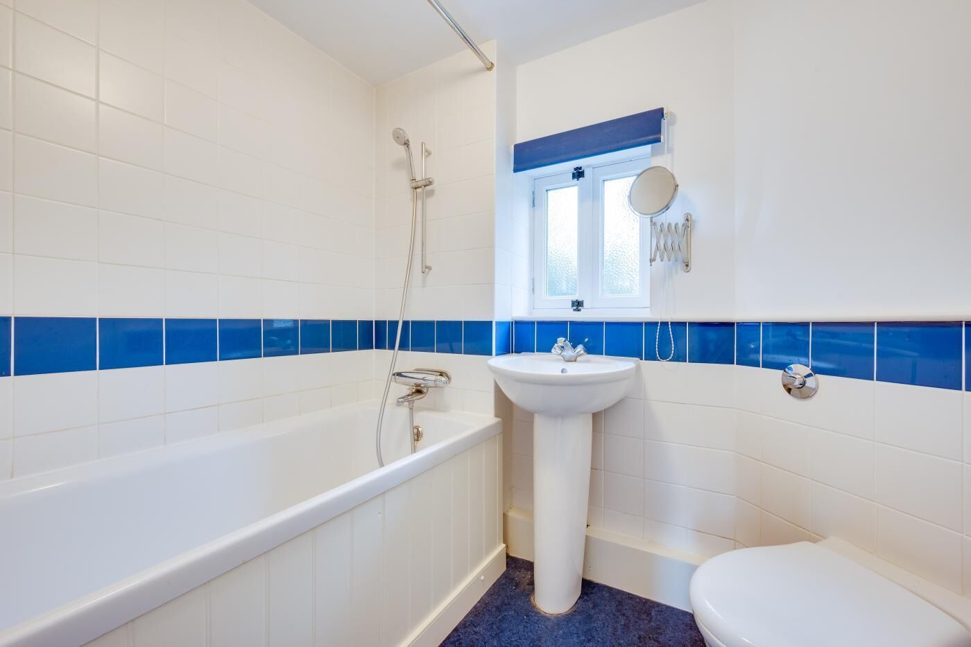 A bathroom with a bathtub, a sink, and a toilet.