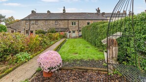 A stone house with a garden, a metal gate, and a flower pot. - 2 Bed in Bolton By Bowland (oc-p33306) (Bolton by Bowland)