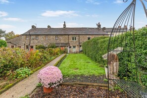 A stone house with a garden, a metal gate, and a flower pot. - 2 Bed in Bolton By Bowland (oc-p33306) (Bolton by Bowland)