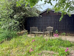 A garden with a wooden bench and a table, a wooden fence, and a shed. - 1 Bed in Clatcombe (oc-s33309) (Castleton)